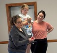 Emily Jacobson on left standing next to a girl and another woman on the right at NE AgrAbility Youth Safety Days