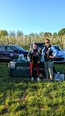 Andrea Garcia and Samantha Wolfe standing outside in front of a MI State Extension table with cars and a field in the background