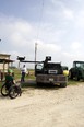 Man in wheelchair looking at flatbed truck with lift attached to it.