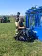 Gregg and John - one in a tracked wheelchair - demonstrating safe livestock handling in a grassy field