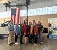 2 men and 6 women - all with TN AgrABility - standing in front of the LifeLyfts truck and banner with a USA flag hanging above them