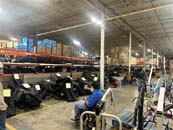Man in wheelchair looking at home medical equipment in FODAC warehouse