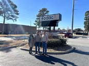 3 members of GA AgrAbility standing outside in front of fodac company sign
