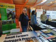 Susan Jaster standing behind table in AgrAbility booth