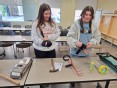 2 occupational therapy students trying small assistive technology items at Indiana University South Bend