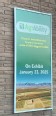 Framed poster on a wall of the NM Farm & Ranch Heritage Museum advertising the AgrAbility exhibit