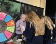 John sharing literature at a booth with 3 female FFA members