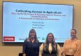 Pic of Rachel Jarman - Christine Mason - & Sarah Jordan in front of a PowerPoint slide presenting CULTIVATING ACCESS TO AGRICULTURE