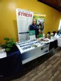 Susan Jaster standing behind MO AgrAbility display for Safety Well-Being Exhibit Health Fair