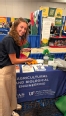 A young woman - Savannah Stephens - pointing to the Agricultural & Biological Engineering  booth