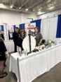 Michelle Bachand in the WI AgrAbility booth with some FFA members at the WI FFA Expo.