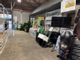 The AgrAbility display with LifeLyfts tractor and display tables and various AT