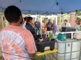 Gabriel Mont-Renaud sharing with a group of people around his aquaponics demonstration unit.