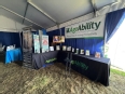 AgrAbility booth with tables in an L shape with literature and AT on display