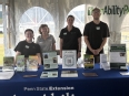 4 AgrAbility for Pennsylvanians staff behind an AgrAbility display table