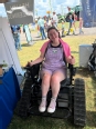 A young woman - Em Kase - sitting in an Action Trackchair smiling at the camera