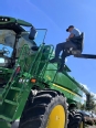 Doug Boswell using a truck lift to get into a combine.