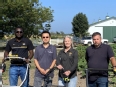 Doug Boswell and Karen Funkenbush with 2 other men standing outside a farm building