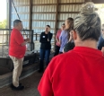 Aaron Yoder sharing with a group of OTs and PTs in a farm building.