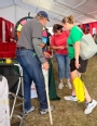 Burton Pflueger sharing with attendees at the AgrAbility booth at Husker Harvest Days