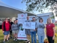 OH AgrAbility staff and others showing a large check from Cursive OH Charity Bike Ride