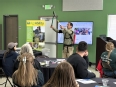 Ned Stoller wearing a shoulder exoskeleton to demonstrate it's use in front of OTs at AT Expo