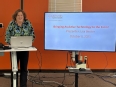 Lisa Becker sharing a PowerPoint titled BRINGING ASSISTIVE TECHNOLOGY TO THE FARM
