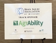 Poster on an easel saying BRAIN INJURY ASSOCIATION OF MISSOURI TRACK SPONSOR - MISSOURI AGRABILITY