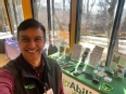 Selfie of Roberto Franco in front of an AgrAbility Virginia display table.