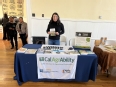 Esme Mandujano behind the CA AgrAbility table at Farmer Wellness Day.