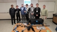 6 young men with Ned Stoller on the right forming the exoskeleton arm support capstone group
