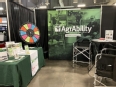 NE AgrAbility booth with table - AgrAbility banner - and spinning wheel game.