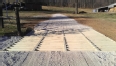 Cattle guard grating installed on a gravel path.