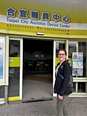 Sam Wolfe standing in front of Taipei City Assistive Device Center in Taiwan.