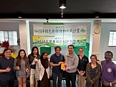 Sam Wolfe standing with farmer association group in Taiwan.