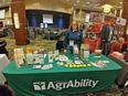 Susan Jaster standing behind the MO AgrAbility table at the Dairy Expo