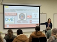 Julie LaJeunesse sharing a PowerPoint presentation in front of a group of people