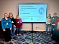 5 women standing on each side of a screen with a PowerPoint slide on it reading BUILDING PARTNERSHIPS TO CREATE AN ACCESSIBLE LIVESTOCK SHOW