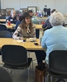 MO Ambassador Advisory Committee members with others working at long tables.