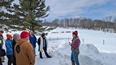 A group from the NTW out in the snow listening to a farmer on rotational grazing