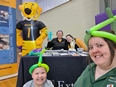 4 ladies - 2 with balloon animals on their heads - at the MO Extension booth