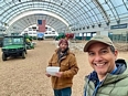 Selfie of Roberto Franco and another gentleman behind him in a very large hoop-house style building